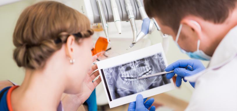 dentist showing woman xray of her teeth