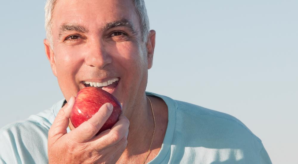 man about to eat an apple